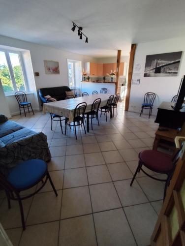 a living room with a table and chairs at F5 à Montjaux in Montjaux