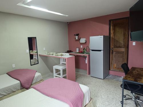 a small room with a kitchen and a refrigerator at Suite 102 Cordoba Centro Estacionamiento in Córdoba