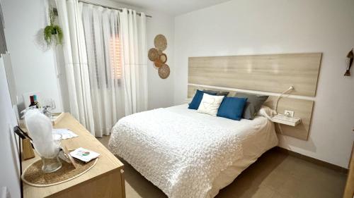 a bedroom with a large bed with blue pillows at Caleta Blue Ocean on the Beach by Deihu Experiences in Adeje