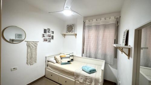 a white room with a bed with a mirror at Caleta Blue Ocean on the Beach by Deihu Experiences in Adeje