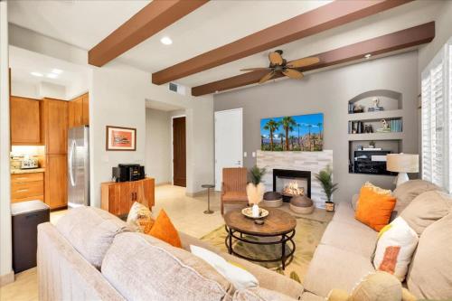 a living room with a couch and a fireplace at Alluring Desert Haven in La Quinta #A in La Quinta
