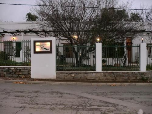 a picture on the side of a white fence at The Barracks in Colesberg