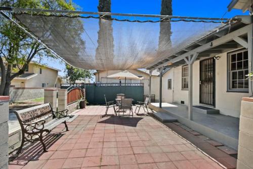 a patio with two benches and a table and chairs at 2BR Pet-Friendly Home # RV FREE in Upland