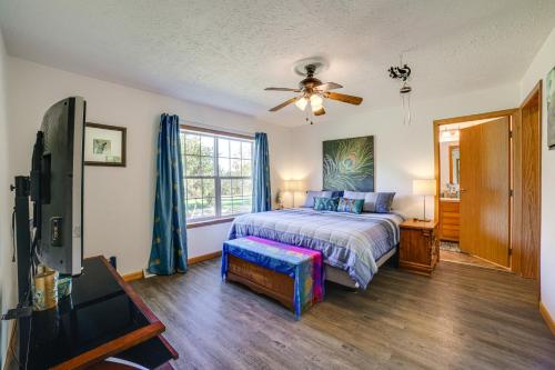 a bedroom with a bed and a flat screen tv at 8-Acre Bridgman Oasis Pool, Hot Tub and Game Room in Bridgman