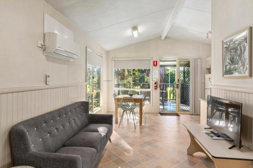 a living room with a couch and a tv at Mittagong Holiday Park in Mittagong