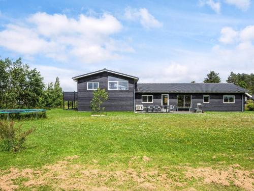 a house with a large yard in front of it at Scandinavian Lakeside Retreat-By Traum in Ansager