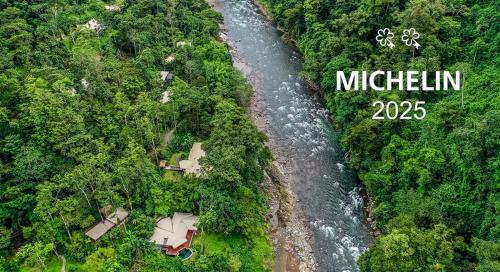 an aerial view of a river in a forest at Pacuare Lodge by Böëna in Bajo Tigre