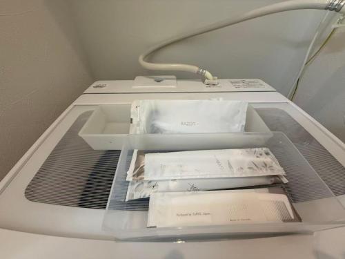 a shelf in a hospital bed with papers in it at Blume 中央区温馨小屋 地铁西18丁目站步行10分钟 in Sapporo