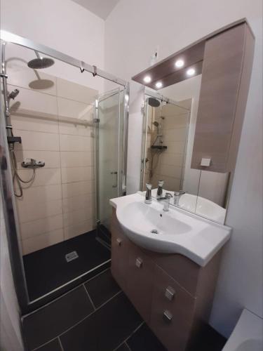 a bathroom with a sink and a shower and a mirror at La Stella Bianca in Sutri