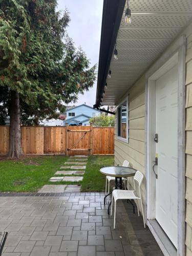 a patio with a table and bench next to a house at Sunny Nook in Richmond