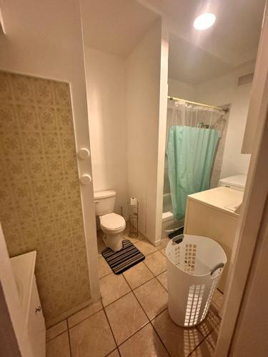 a small bathroom with a toilet and a shower at Big APP With 3bd For 8 people in Montréal
