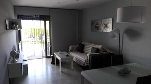 a living room with a couch and a table at ROMERO APARTMENTS-ARENALES DEL SOL in Arenales del Sol
