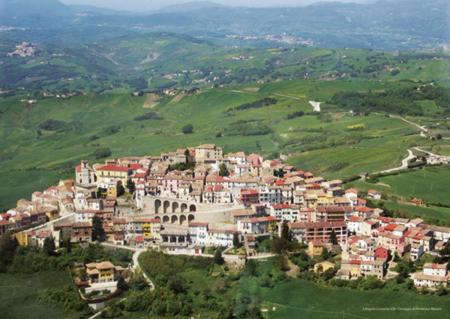 a town on top of a green hill with houses at Perbacco in SantʼAngelo Limosano
