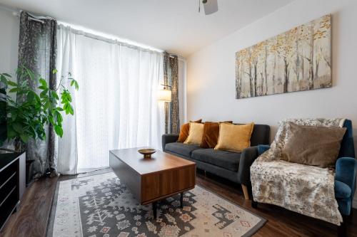 a living room with a couch and a coffee table at Cozy Family Home Near Montreal in Brossard