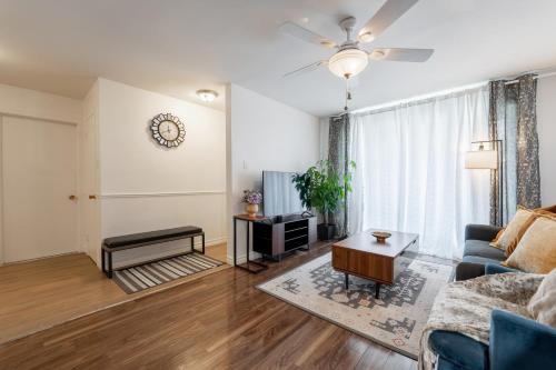 a living room with a couch and a table at Cozy Family Home Near Montreal in Brossard