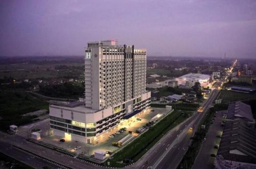 a large building with lights on in a city at Putri Hotel at Mydin Tunjong in Kota Bharu