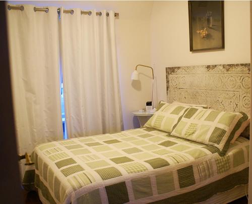 a bedroom with a bed and a window with a curtain at Yarra Valley Views in Lilydale