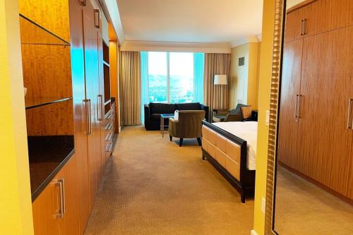 a hospital room with a bed and a living room at Five Star Trump Hotel No Resort And Cleaning Fees in Las Vegas