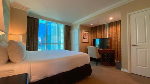 a hotel room with a bed and a television at Mgm 1 Bedroom Balcony And Or Studio Luxury Suites in Las Vegas