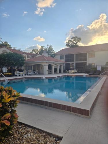 a large swimming pool in front of a building at Paradise Villa in Titusville