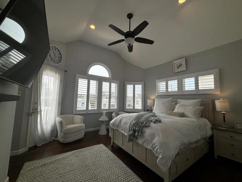 a bedroom with a bed and a ceiling fan at Wifi Decks Private Yard Beach Badges Beach Chairs Keurig Os Wd 3Rd Off The Beach in Brant Beach