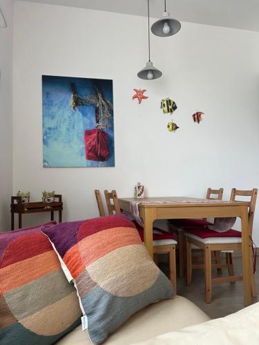 a bedroom with a table and a bed with a blanket at ARTs at Portovenere in Portovenere