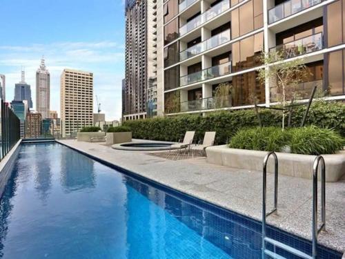 a swimming pool on the roof of a building at ADEK Apartments Melb Central-Modern City Escape in Melbourne