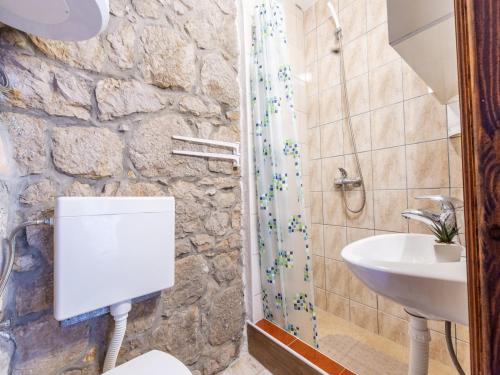 a bathroom with a toilet and a sink at Rustical Resort Kokori i with Shared Outdoor Swimming Pool - One Bedroom Apartment with Terrace in Višnjica