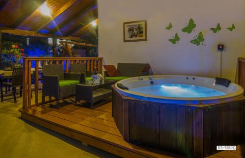 a large jacuzzi tub in a room with a patio at Beautiful Countryside House in Tiberias