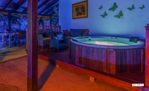 a jacuzzi tub in a living room with a table at Beautiful Countryside House in Tiberias
