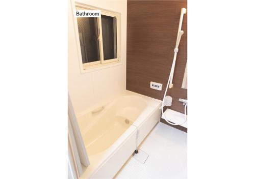 a white bath tub in a bathroom with a window at f life house - Vacation STAY 18973 in Koriyama