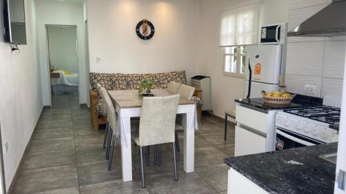 a kitchen with a table and chairs in a kitchen at Departamento Abril Sierras in Tandil