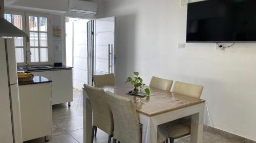 a kitchen with a table with chairs and a dining room at Departamento Abril Sierras in Tandil