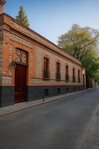 a brick building on the side of a street at Hacienda Gobernadores Boutique Stay in a Historic 19th-Century Hacienda in Mexico City