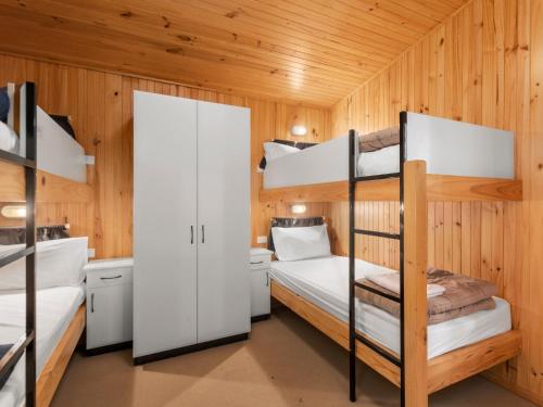 a room with two bunk beds in a cabin at Shoalhaven Heads Village in Shoalhaven Heads