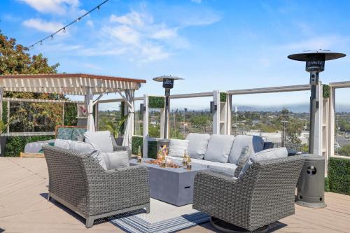 a patio with wicker chairs and a table on a deck at The Sky Lounge in La Mesa