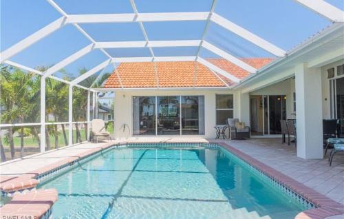 a swimming pool in a house with a roof at Sunshine paradise retreat with heated pool and canal access in Cape Coral