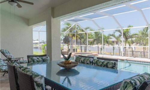 a swimming pool with a table and a fountain at Sunshine paradise retreat with heated pool and canal access in Cape Coral