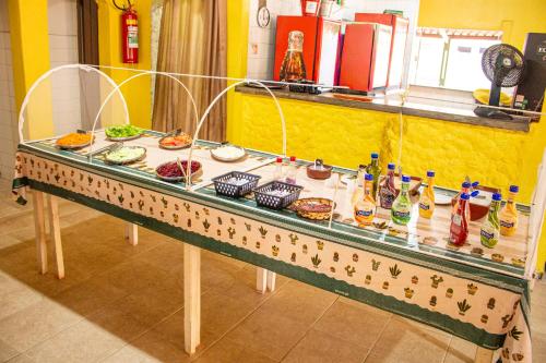 a buffet table with food and drinks on it at Parque Pousada Macaquinho Turismo in Serra Negra