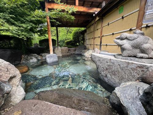 a pool of water with a teddy bear sitting on top of it at Hataya Onsen Sasa no yu in Katashina