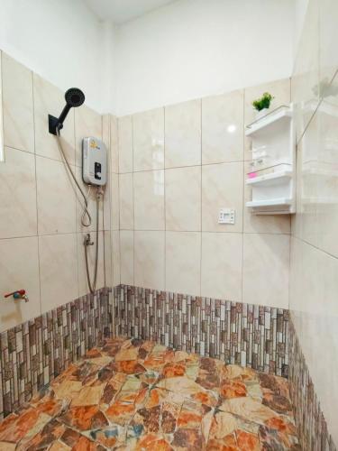 a bathroom with a shower with a mosaic floor at Rimlay Bay View in Ko Yao Noi