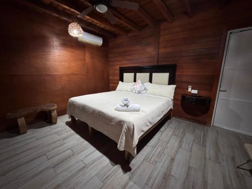 a bedroom with a bed with a teddy bear on it at Hotelito Villas Holbox in Holbox Island
