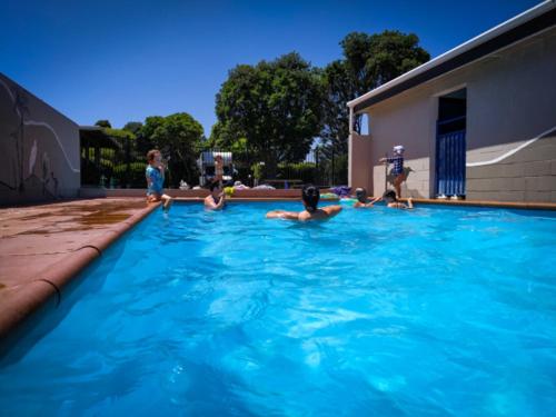 a group of people in a swimming pool at New Plymouth TOP 10 Holiday Park in New Plymouth