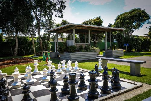 a chessboard in a garden with a gazebo at New Plymouth TOP 10 Holiday Park in New Plymouth