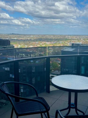 a table and chairs on a balcony with a view at Spacious 4BR penthouse in Box Hill Free Parking x 2 in Box Hill