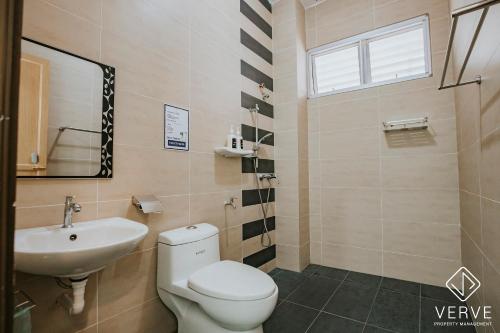 a bathroom with a white toilet and a sink at Ipoh Gateway by Verve 4R4B - 14 Pax in Ipoh