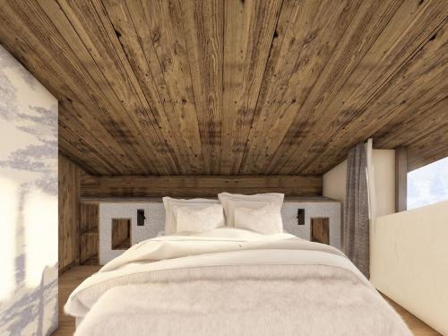a bedroom with a large bed with a wooden ceiling at Chalet moderne avec sauna et jacuzzi à Courchevel pour 8 adultes et 5 enfants - FR-1-562-89 in Courchevel