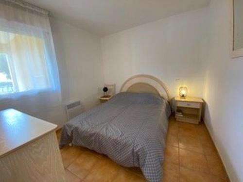 a small bedroom with a bed and a window at Appartement 3 pièces avec climatisation dans résidence avec piscines et tennis - FR-1-100-364 in Cavalaire-sur-Mer