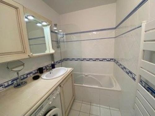 a bathroom with a sink and a bath tub at Appartement 3 pièces avec climatisation dans résidence avec piscines et tennis - FR-1-100-364 in Cavalaire-sur-Mer