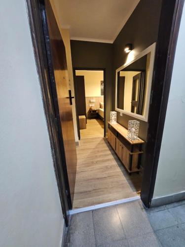 a hallway of a bathroom with a sink and a mirror at Departamento Ejecutivo 10 m de la Catedral Tango 10 in San Fernando del Valle de Catamarca